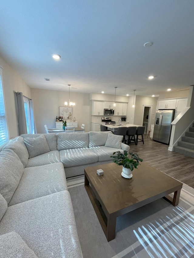 living room with dark hardwood / wood-style floors and a chandelier