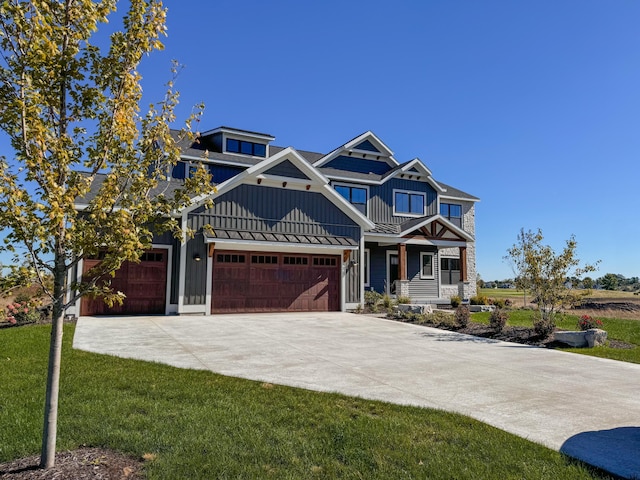 view of front of home with a garage, a porch, and a front lawn