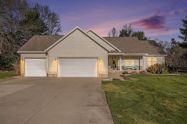 view of front of house featuring a yard and a garage