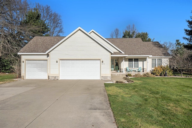 ranch-style house featuring a garage and a front lawn