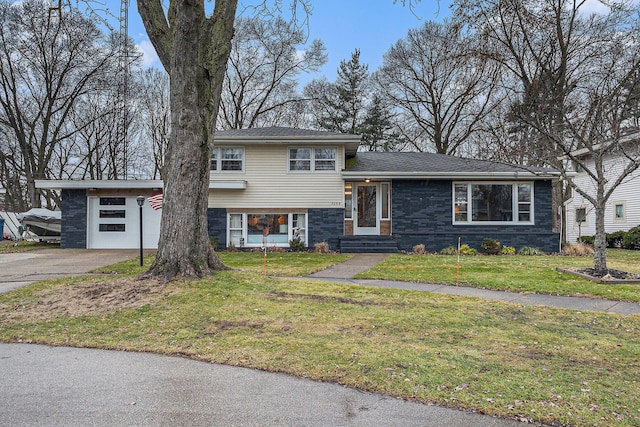 tri-level home featuring a garage and a front lawn