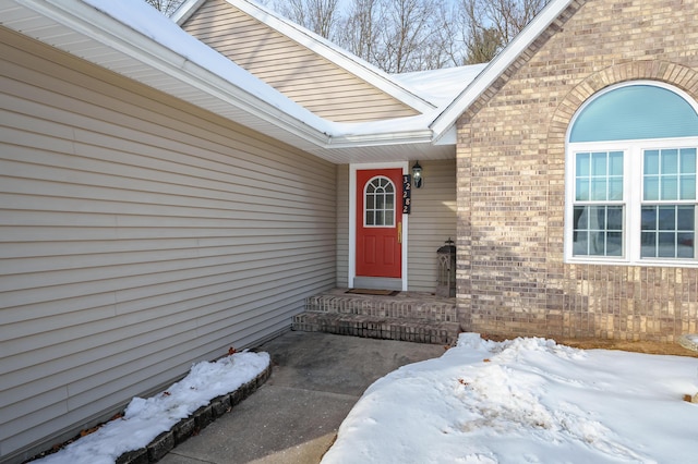 view of snow covered property entrance