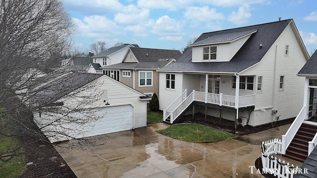 back of property with a porch and a garage