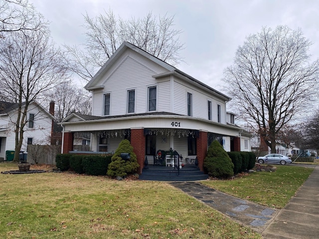 view of front facade with a porch and a front lawn