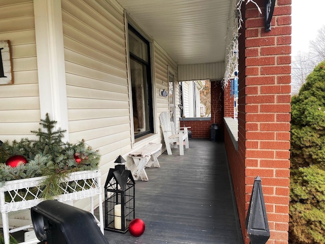 wooden terrace featuring covered porch