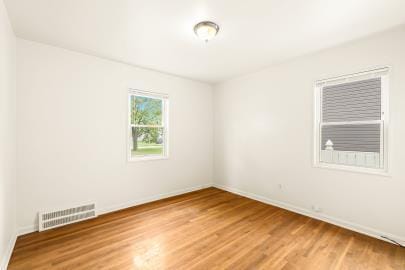 spare room featuring hardwood / wood-style floors