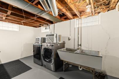 laundry room with independent washer and dryer and sink