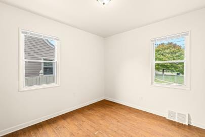 spare room with hardwood / wood-style floors