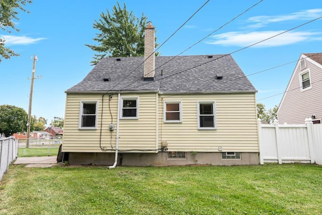 back of property featuring a yard