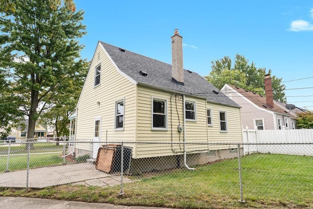 rear view of house with a yard and a patio