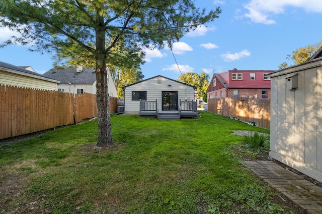 back of property featuring a yard and a deck