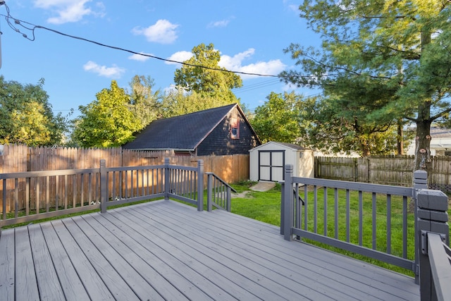 deck featuring a lawn and a storage shed