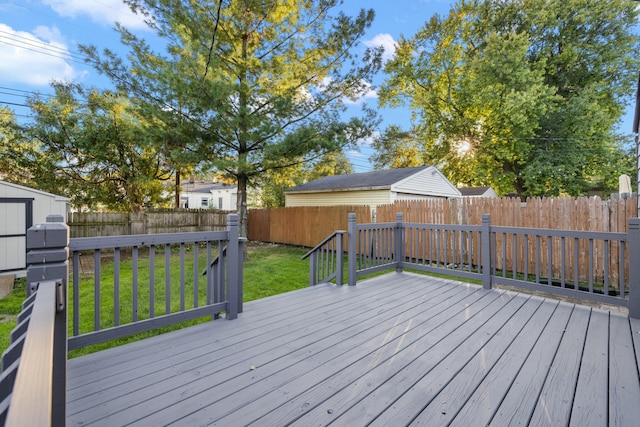 wooden terrace featuring a lawn