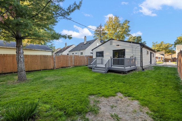 back of house featuring a yard and a wooden deck