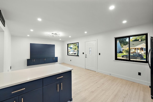 interior space featuring light wood-type flooring and blue cabinets