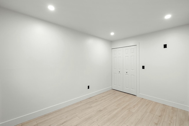 empty room with light hardwood / wood-style flooring