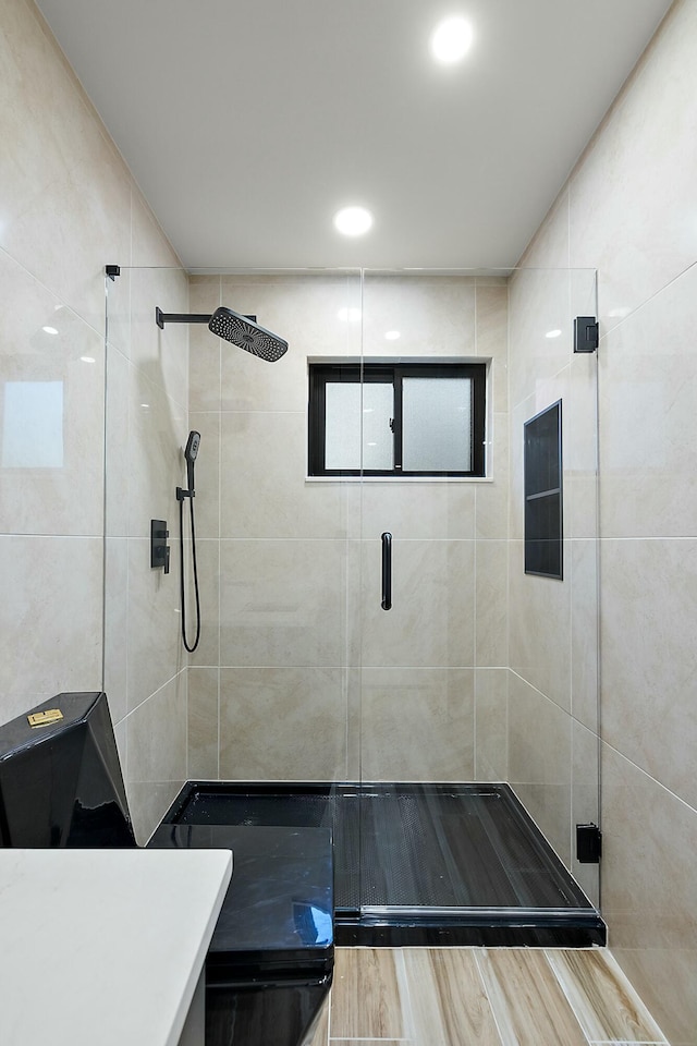 bathroom with a shower with door