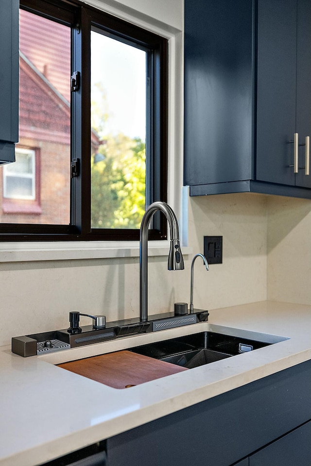 kitchen featuring blue cabinetry and sink