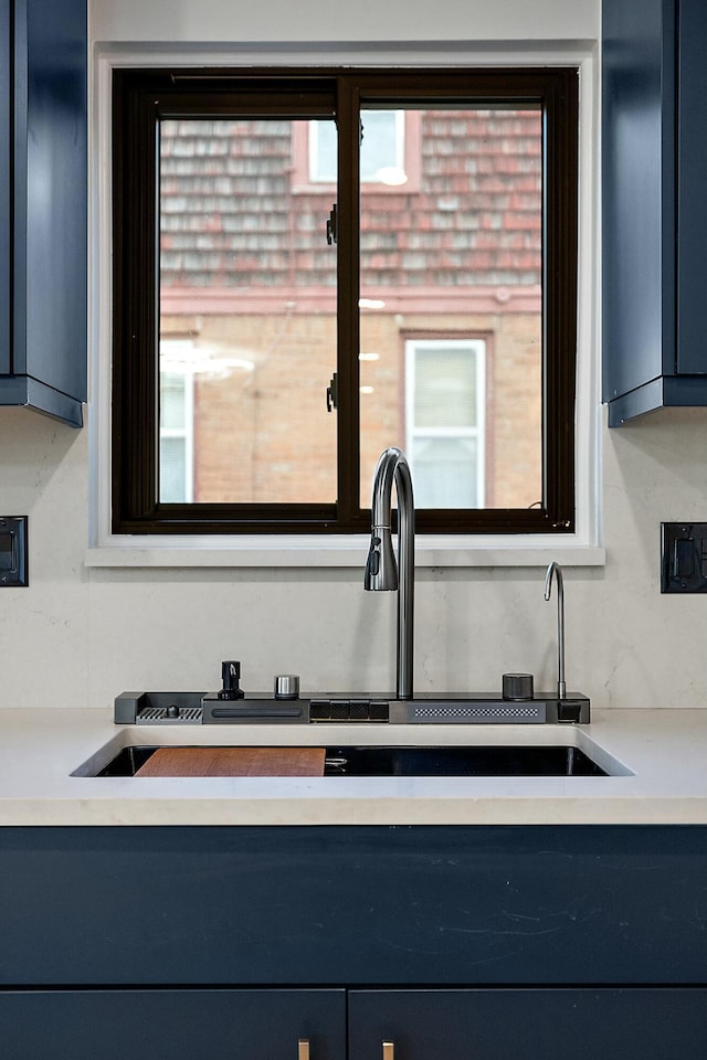 interior details featuring blue cabinetry and sink