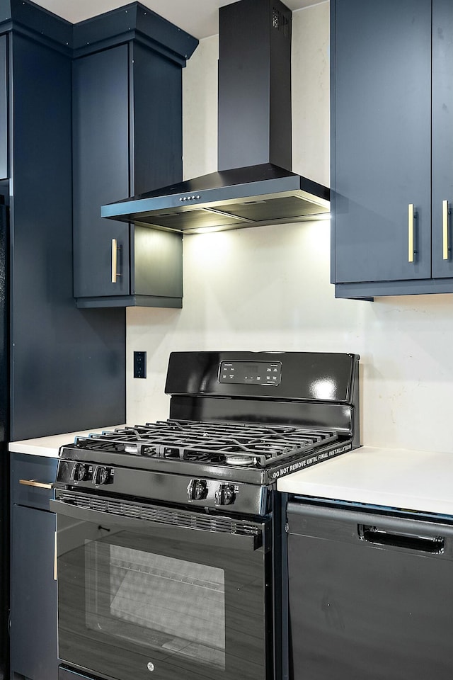 kitchen with blue cabinetry, black appliances, and wall chimney range hood