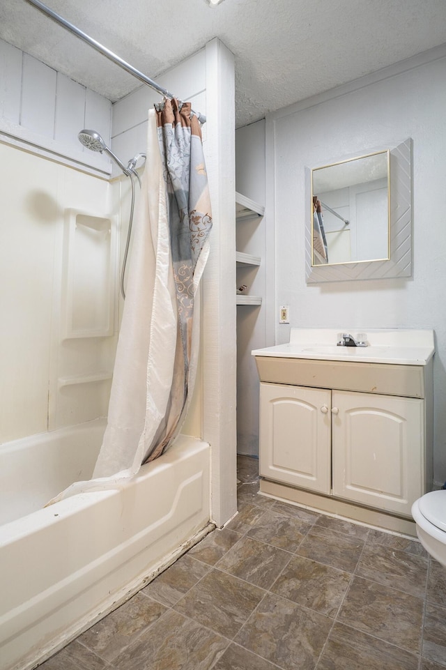 bathroom featuring shower / bath combo, a textured ceiling, and vanity