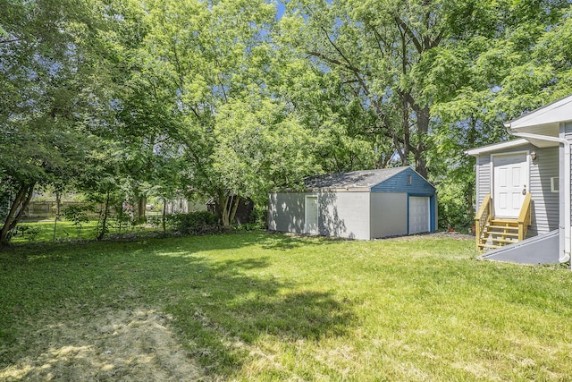 view of yard featuring an outbuilding and a garage