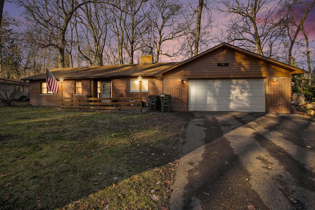 single story home with a yard and a garage