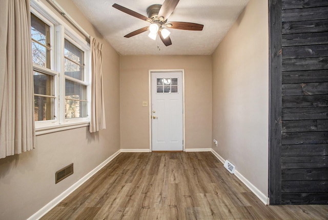 interior space featuring hardwood / wood-style flooring, ceiling fan, a healthy amount of sunlight, and a textured ceiling