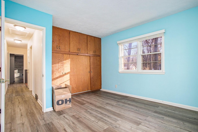 unfurnished bedroom with light hardwood / wood-style floors