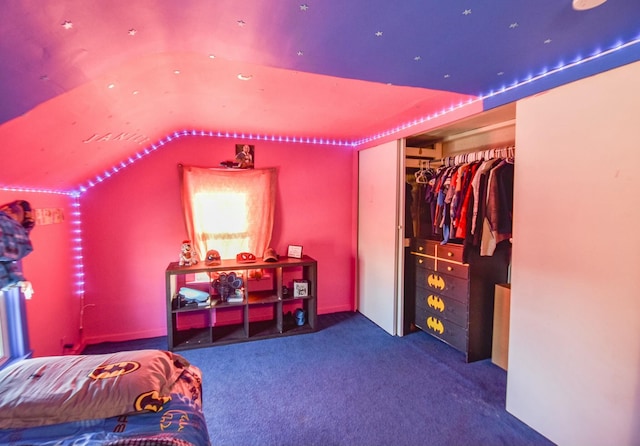 carpeted bedroom with lofted ceiling and a closet