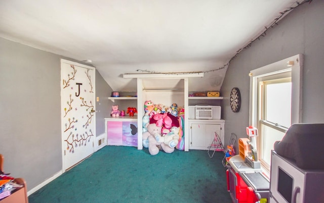 rec room featuring dark carpet and lofted ceiling