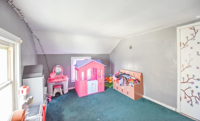 playroom with carpet floors and vaulted ceiling