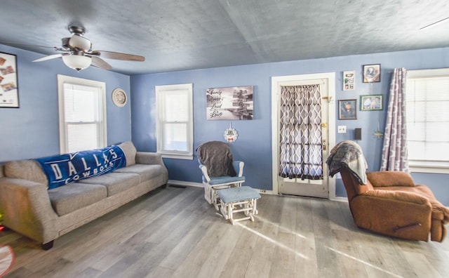 living room featuring hardwood / wood-style flooring and ceiling fan