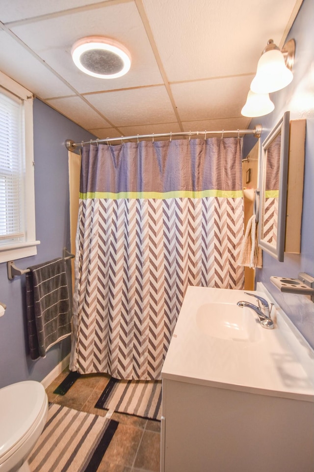 bathroom featuring a paneled ceiling, a shower with curtain, vanity, and toilet