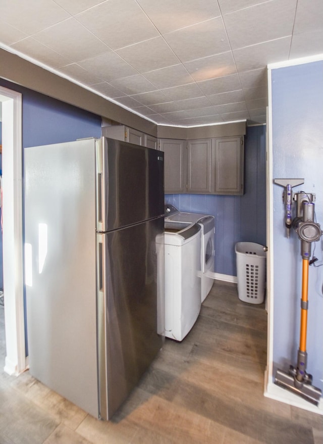 laundry room featuring light hardwood / wood-style floors and washer and clothes dryer