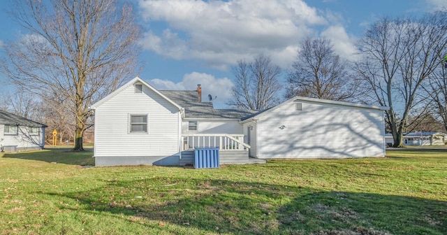 back of property featuring a lawn