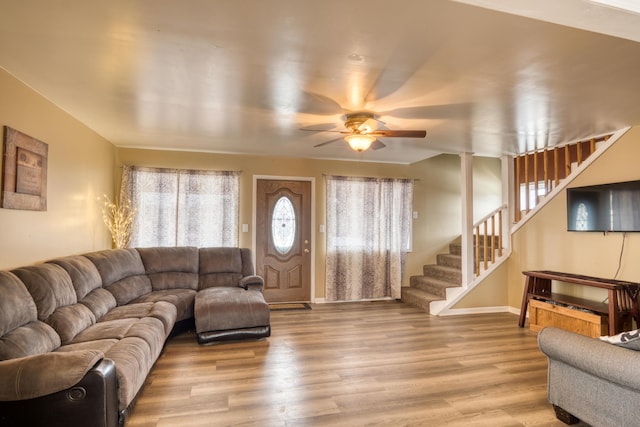 living room featuring ceiling fan, a wealth of natural light, and light hardwood / wood-style flooring