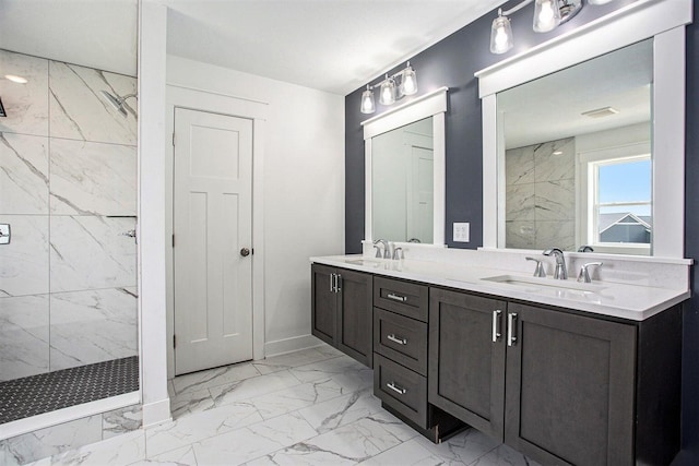 bathroom with a tile shower and vanity