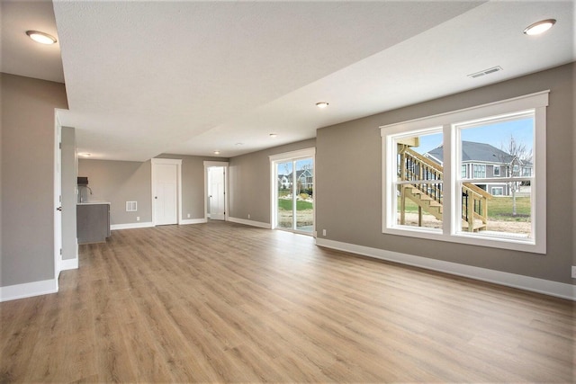 unfurnished living room with light wood-type flooring