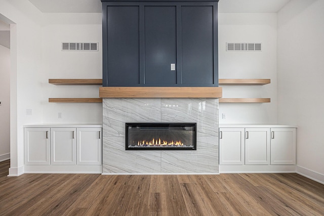 3545 Conrail Dr, Byron Center, MI 49315 - detailed view of wood finished floors, baseboards, and a high end fireplace