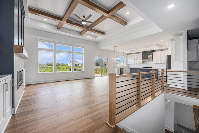 3545 Conrail Dr, Byron Center, MI 49315 - interior space featuring plenty of natural light, wood finished floors, beam ceiling, ceiling fan, and coffered ceiling