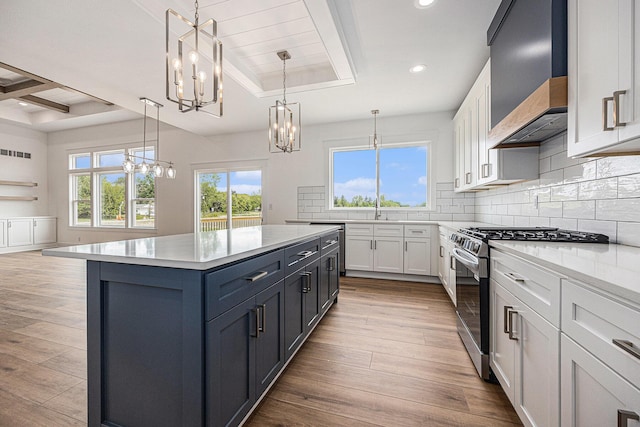 3545 Conrail Dr, Byron Center, MI 49315 - kitchen with stainless steel gas range oven, a chandelier, extractor fan, beamed ceiling, and a sink