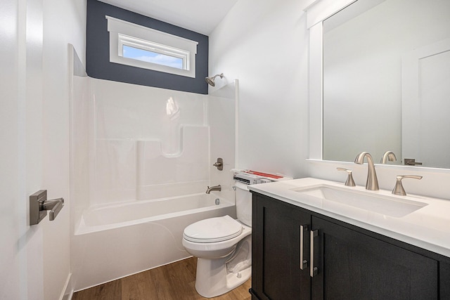 3545 Conrail Dr, Byron Center, MI 49315 - bathroom featuring vanity, wood finished floors, washtub / shower combination, and toilet