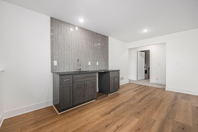 3545 Conrail Dr, Byron Center, MI 49315 - indoor wet bar with light wood finished floors, baseboards, recessed lighting, and tasteful backsplash