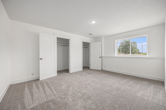 3545 Conrail Dr, Byron Center, MI 49315 - unfurnished bedroom with carpet, baseboards, recessed lighting, and multiple closets