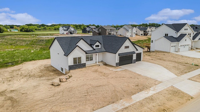 3545 Conrail Dr, Byron Center, MI 49315 - modern inspired farmhouse with a garage, a residential view, driveway, stone siding, and a shingled roof