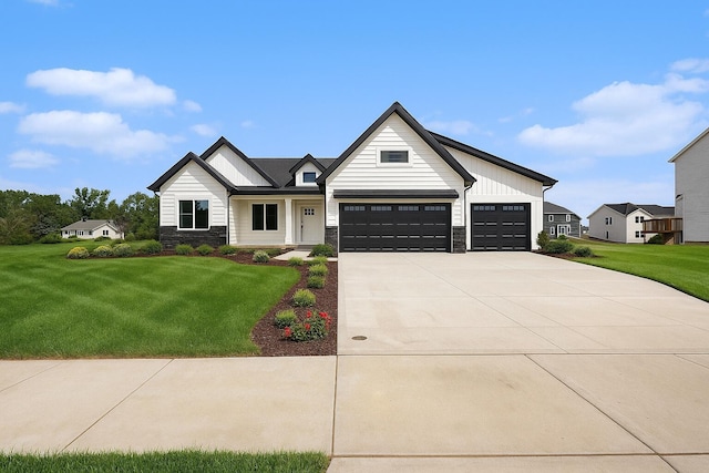 3545 Conrail Dr, Byron Center, MI 49315 - modern inspired farmhouse featuring stone siding, a front lawn, concrete driveway, and a garage