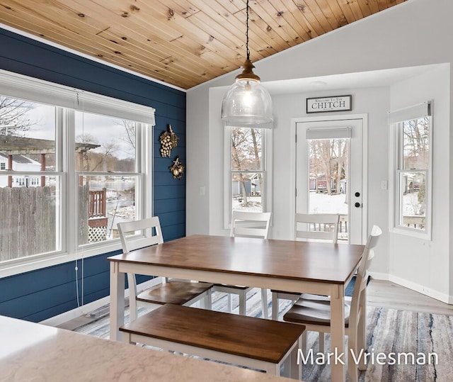 dining space featuring wood-type flooring, wooden ceiling, and vaulted ceiling