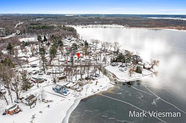 snowy aerial view featuring a water view