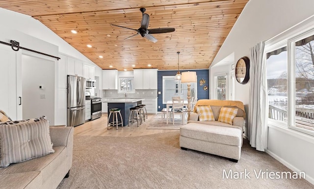 living room featuring light carpet, vaulted ceiling, ceiling fan, and wooden ceiling